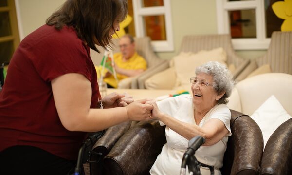 Professional caregiver providing walking assistance to senior client in Louisville KY