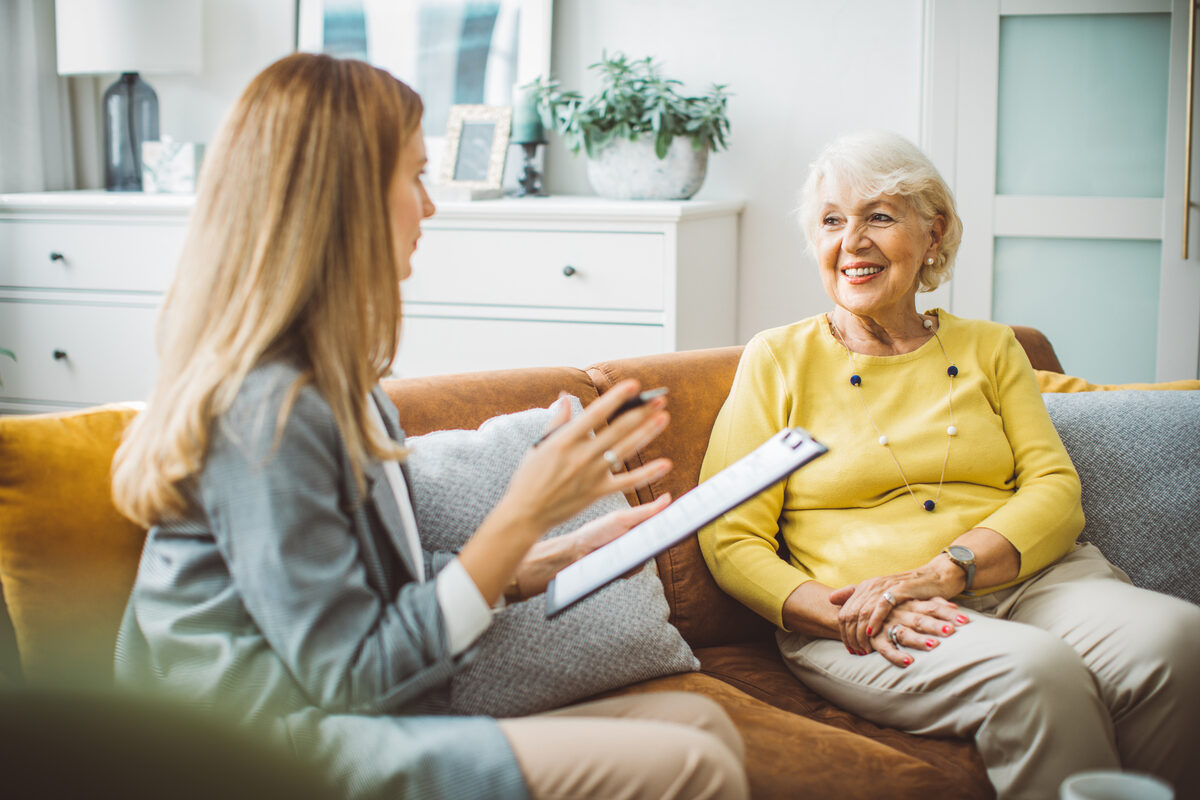 Care coordinator speaking with senior at home for in your area service inquiry