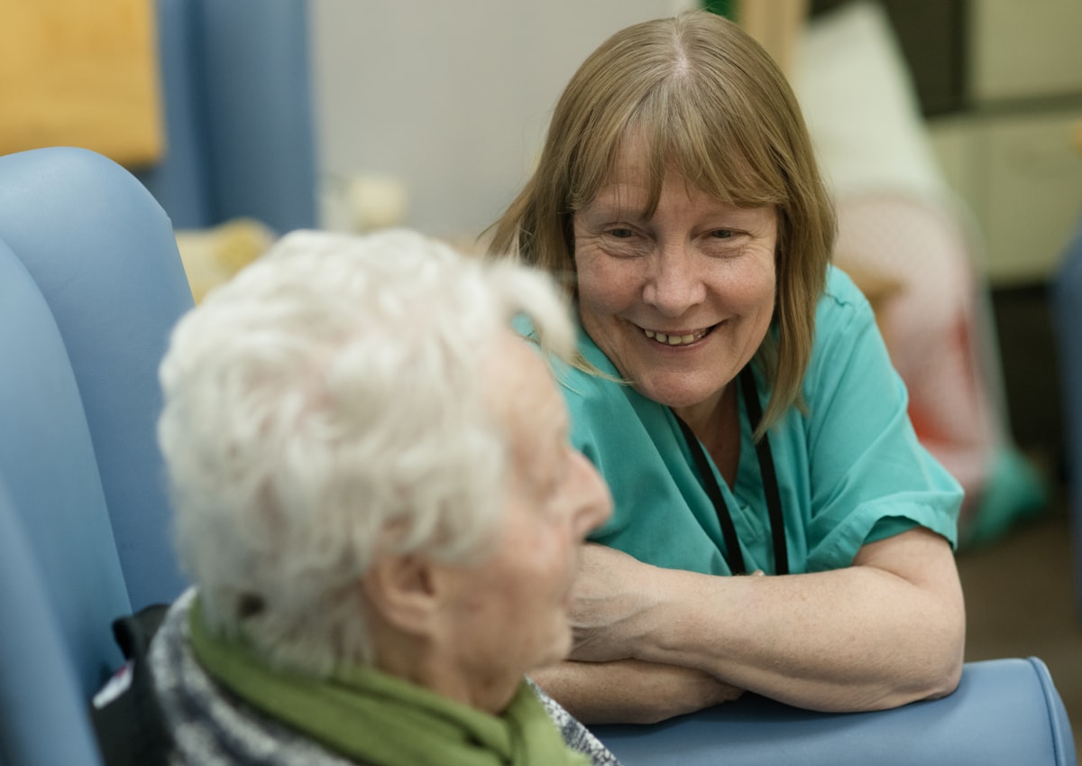 Caregiver warmly engaging with senior woman in home setting - Viva Senior Services Louisville KY