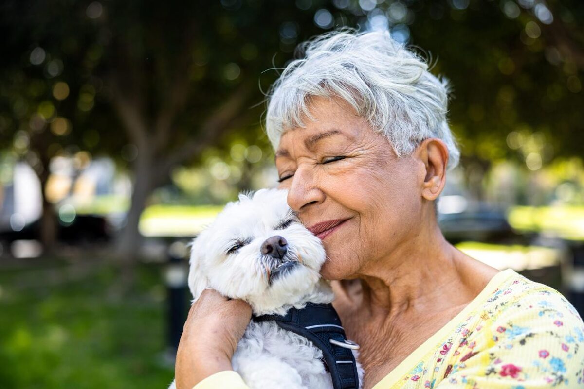 Senior woman smiling with her dog for Viva Senior Services about section